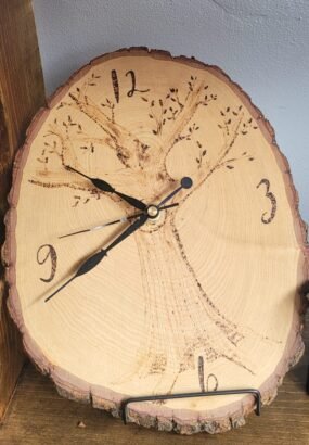 Wooden clock with burned tree